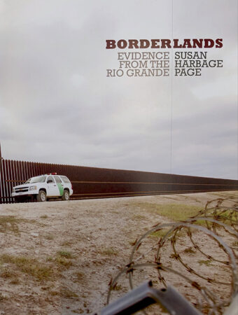 Borderlands catalog cover, featuring a photo of the border wall between Texas, USA and Mexico
