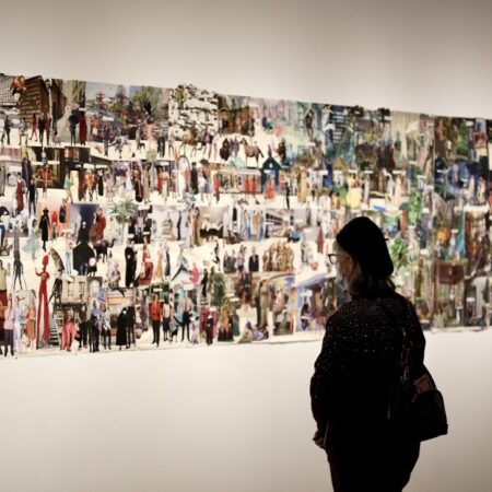 A visitor takes in the large-scale collage titled Shakespeare in the Park at the opening reception of This is Not: Aldwyth in Retrospect